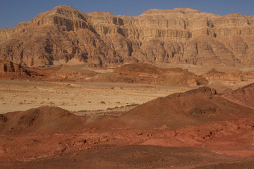 The famous Timna National Park in the desert in southern Israel in the Eilat region. Sand cliffs, dry land, red sand in the form of pillars and mushrooms. Sights of Israel.