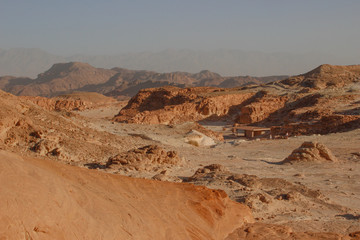 Fototapeta premium The famous Timna National Park in the desert in southern Israel in the Eilat region. Sand cliffs, dry land, red sand in the form of pillars and mushrooms. Sights of Israel.