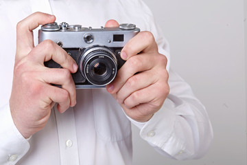 Fototapeta premium young man holding a camera