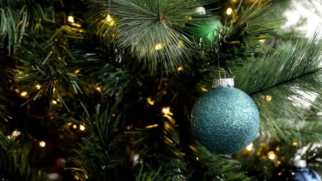  Blinking lights on Christmas tree with baubles 4K video