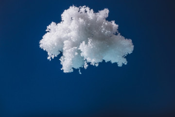 Fototapeta na wymiar white fluffy cloud made of cotton wool isolated on dark blue