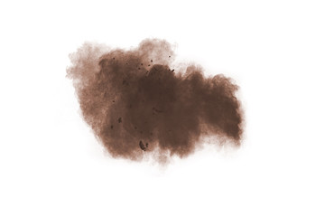 Freeze motion of brown dust explosion on white background. Throwing brown powder out of hand against white background.