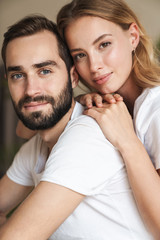Fototapeta premium Beautiful happy young couple in love embracing at home