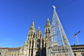 Cathedral from Praza do Obradoiro with Christmas led tree and blue sky. Santiago de Compostela, Spain.