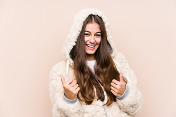 Young caucasian woman posing isolated raising both thumbs up, smiling and confident.