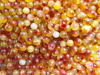Close up small yellow beads background.