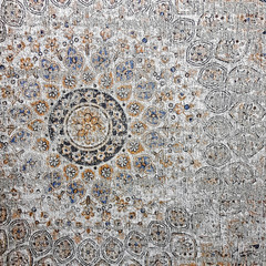 Aged ceramic tile with floral and geometric pattern for wall and floor decor. Concrete stone surface background. Oriental texture with mandala for interior design project.