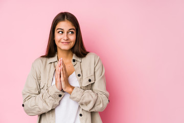 Young caucasian woman posing in a pink background making up plan in mind, setting up an idea.