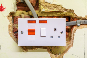 electric socket in a wall during renovation in england uk