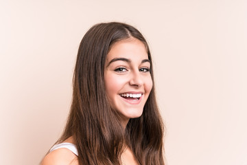 Young cute caucasian woman against a beige background