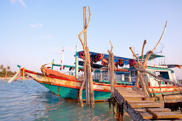 Traveling by Thailand. Ocean, beach and old fishing boat.