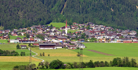 Fototapeta na wymiar Austria europe mountain landscape with village and natural scene grass lands.