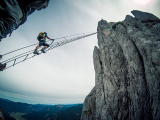 Via ferrata Intersport Klettersteig - climbing up a long ladder - obrazy, fototapety, plakaty