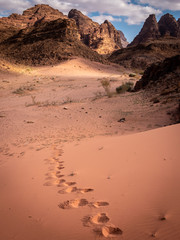 Fototapeta na wymiar Footsteps walking alone in Wadi Rum desert, Jordan