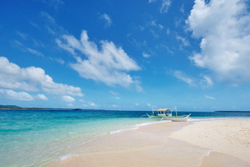 Beautiful landscape with tropical white sand beach with fishing boat. Siargao Island, Philippines.