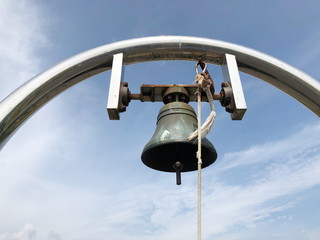 Brass metaled big bell with sky background