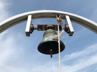 Brass metaled big bell with sky background