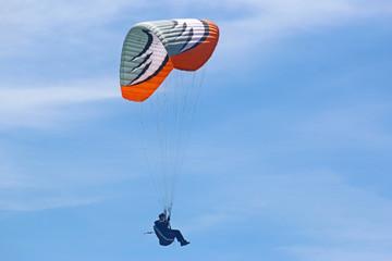 Paraglider flying wing in a blue sky	