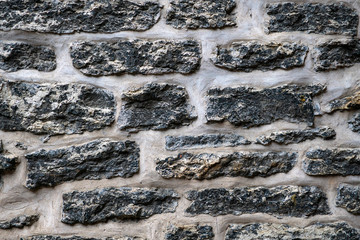old fortress black wall texture. the texture of the stone masonry of the black bricks