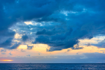 Naklejka na ściany i meble Sky with clouds above the sea after sundown
