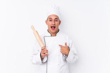 Young latin chef man isolated surprised pointing at himself, smiling broadly.