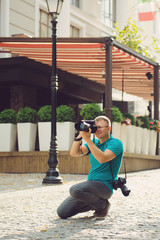 smiling photographer working in street