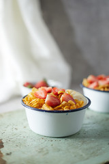 Bowl with cornflakes on background..