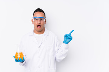 Young latin cientific man isolated  pointing to the side