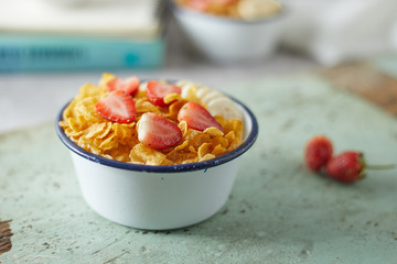 Bowl with cornflakes on background..