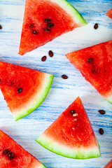 Pieces of watermelon on a blue wooden table