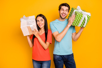 Photo of two funny guy lady people holding hands big giftboxes wondered to know what is inside wear...