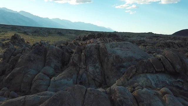 Magical Alabama Hills and Californian Desert in Valley Under Golden Hour Sunlight. Cinematic Aerial Pull Up View