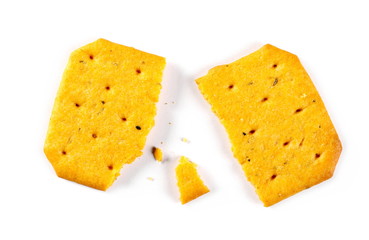 Salty broken, crumbled cracker, snack isolated on white background, top view
