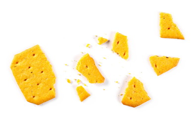 Salty broken, crumbled cracker, snack isolated on white background, top view