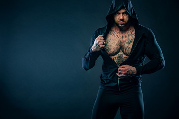 Muscular fitness sports man, atlete with chains in fitness gym. Energy and power.