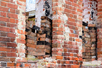 Fragment of a destroyed brick wall with empty windows