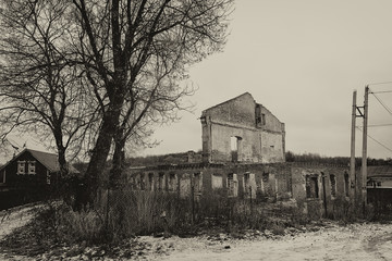 Abandoned ruined house on the outskirts of the village, empty windows