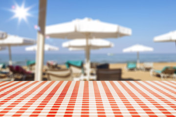 Desk of free space and blurred background of summer bar. 