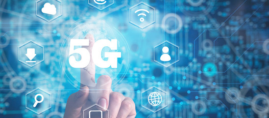 5G,Business, Technology, Internet and network concept. Young businessman working on a virtual screen of the future and sees the inscription: 5G.Connect global wireless devices