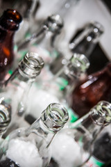 Glass bottles in container, close up