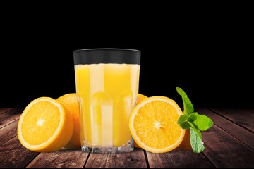 Orange juice and slices of orange on wooden desk © BillionPhotos.com