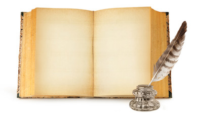 Isolated old book with copy space. Glass ink bottle and quill and one open book with empty yellow...