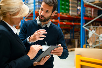 Managers in Warehouse discuss about business	