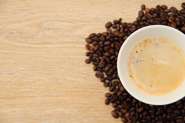 a cup with coffee and coffee beans