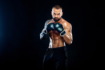 Fitness and boxing concept. Boxer, man fighting or posing in gloves on black background. Individual sports recreation.