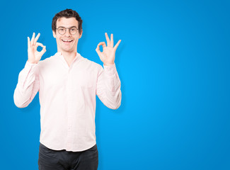 Naklejka premium Surprised young man with a gesture of approval