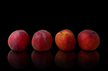 Ripe nectarine fruit isolated on black background.