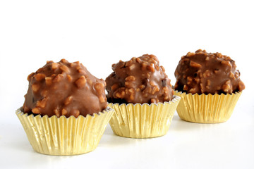 Homemade chocolate hazelnut balls on white background