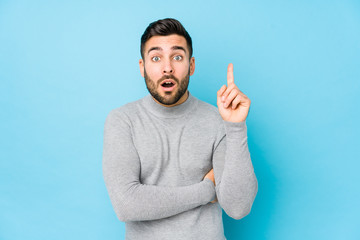 Young caucasian man against a blue background isolated having some great idea, concept of creativity.