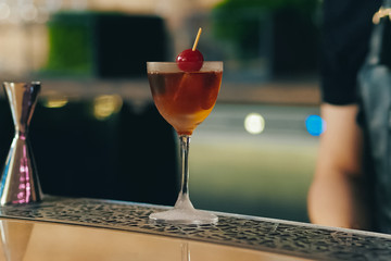 Bartender pouring cocktail at bar counter